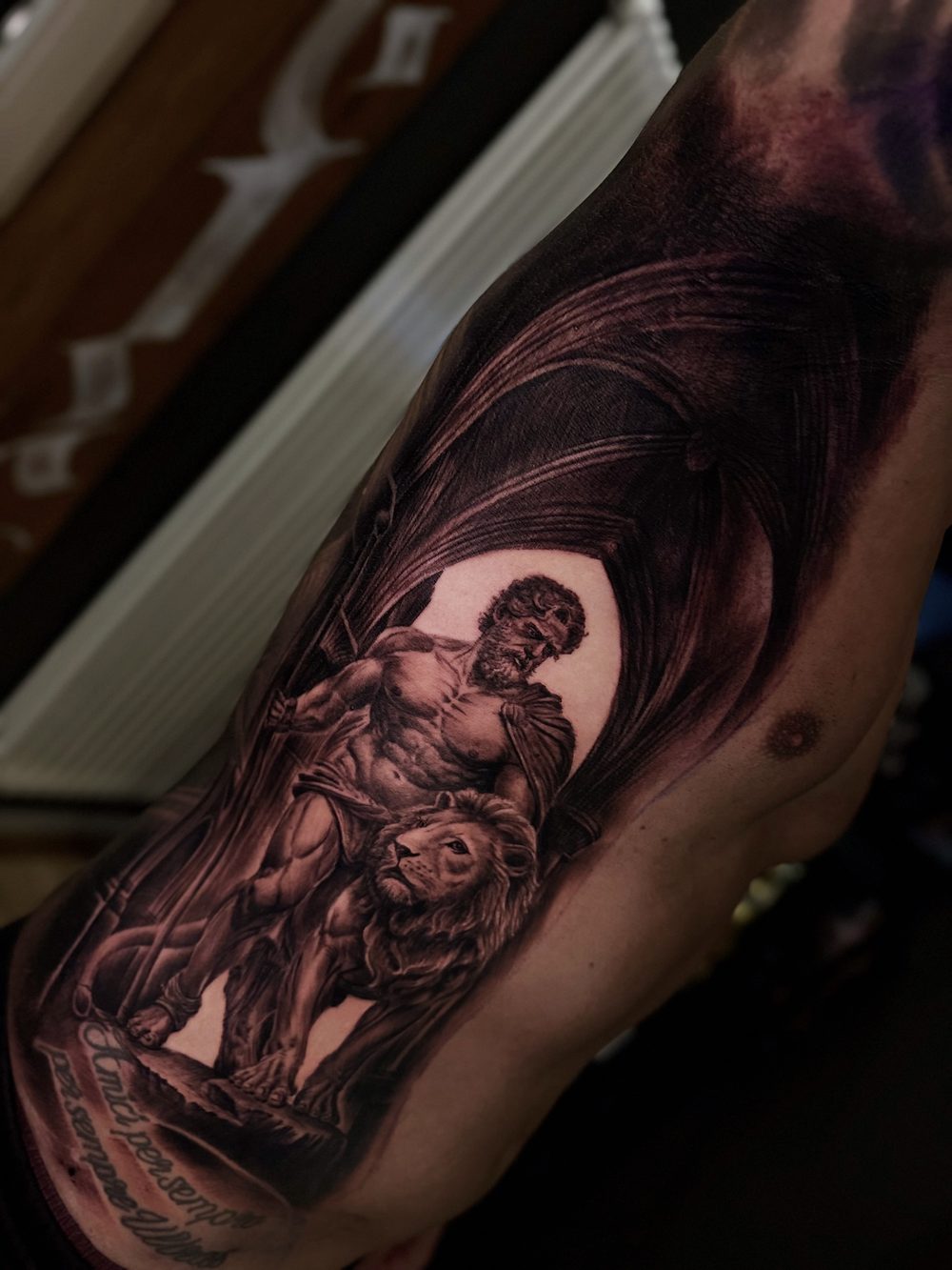 Oberarmtattoo mit Statuenmotiv